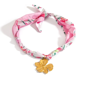 Detail of silk neck scarf necklace with a large golden matte flower pendant