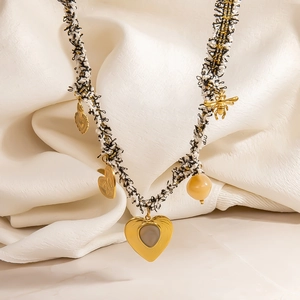 Retro woven chain necklace with gold heart pendants and bee charm on silk fabric