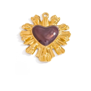 Detailed macro view of heart-shaped pendant with purple enamel and golden sunray texture