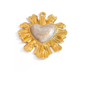 Detailed macro view of a golden vintage heart pendant with sunburst relief pattern