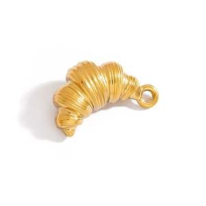 Macro view of gold croissant-shaped pendant showing twisted texture and polished metallic finish