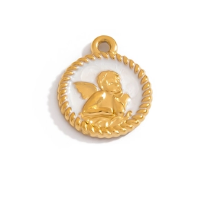Detail view of a vintage cherub angel relief on white enamel and gold-plated pendant