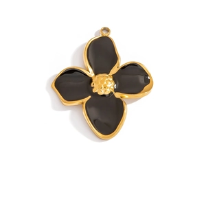 Detail of a black enamel flower pendant with gold edges and textured center core
