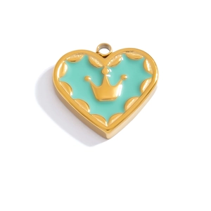 Detail of heart-shaped gold pendant with mint green enamel and a 3D golden crown pattern