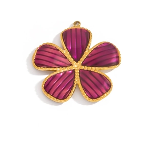 Detailed macro view of a rose pink flower pendant with gold beaded edges and a metal ring