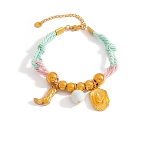 Detailed view of woven cowboy bracelet featuring golden boot and hat charms with beads
