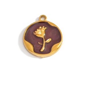 Macro detail of a vintage golden rose pendant with deep burgundy enamel and glitter