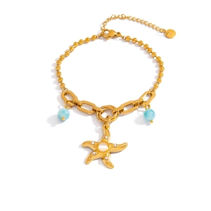Gold starfish charm bracelet with blue beads and opal inlay on bead chain link
