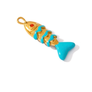 Detail shot of golden fish pendant with blue enamel wave pattern and red zircon eye