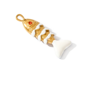 Detailed view of bohemian gold fish charm with white enamel and red stone eye