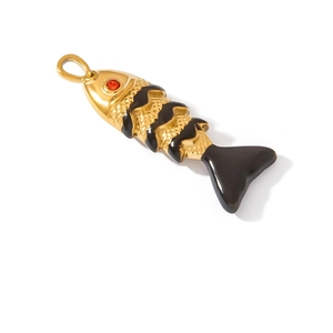 Detail of a fish-shaped pendant in gold metal with black enamel waves and a red zircon eye