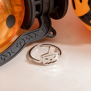 Macro detail of silver stainless steel Halloween ring with hollow pumpkin and witch hat