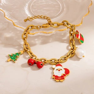Golden Christmas charm necklace with Santa, reindeer, bells and tree on glass plate