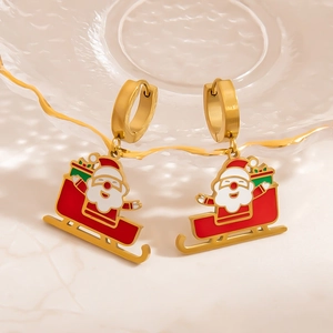 Detail of Christmas earrings featuring Santa Claus on a red sleigh with gold finish