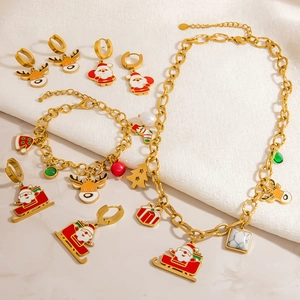 Detailed set of Christmas jewelry featuring golden reindeer and Santa Claus enamel charms