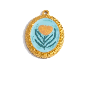 Detail of 18K gold-plated oval pendant with blue enamel and orange floral motif
