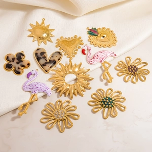 Variety of 18K gold plated stainless steel pendants including sun, heart and flamingo shapes