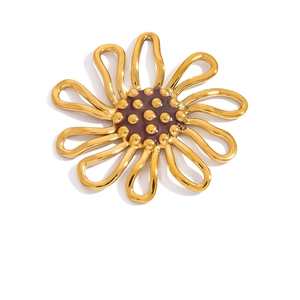 Detailed macro of 18K gold sunflower pendant with intricate hollow metal petals