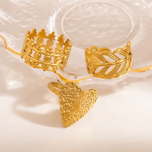 Detail view of 18k gold plated stainless steel ring set with crown and heart designs