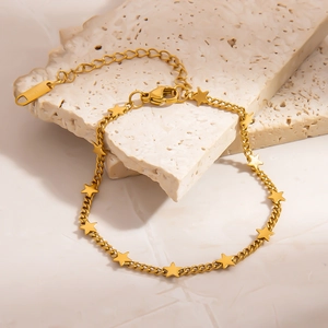 Elegant 18K gold plated stainless steel bracelet with multiple stars on stone background