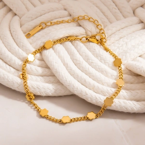 Detailed close-up of 18K gold plated stainless steel bracelet with tiny floral charms