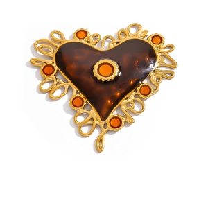 Detail view of heart-shaped vintage brooch with 18K gold finish and tortoise shell pattern