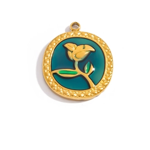 Detail of 18K gold plated round pendant with green enamel and vintage rose engraving