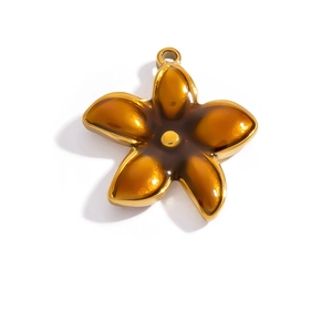 Detailed close-up of a 18K gold-plated floral pendant with amber resin center