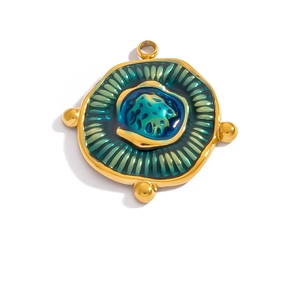 Macro shot of 18K gold plated vintage round pendant with teal enamel and pearl bead accents