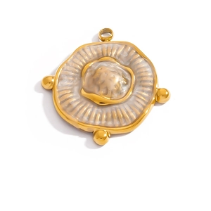 Macro detail of an irregular round 18K gold-plated pendant with relief carving
