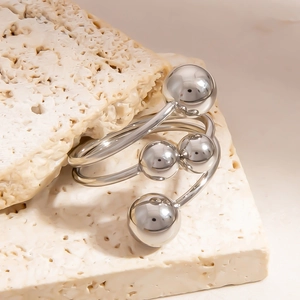Macro detail of a silver multi-bead spiral ring with polished geometric spheres