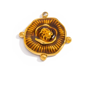 Detail of vintage 18K gold plated stainless steel pendant with textured lotus seed pattern