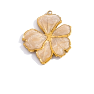 Detailed close-up of a 18K gold plated flower pendant with marble enamel inlay