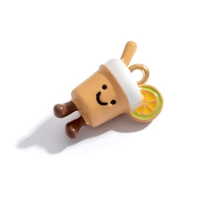 Macro shot of a cute cartoon milk tea charm with a smiley face and lemon slice detail