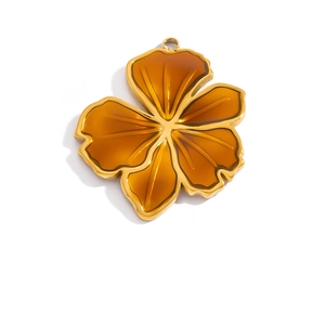 Detailed macro view of an amber resin flower pendant with a 18K gold-plated frame