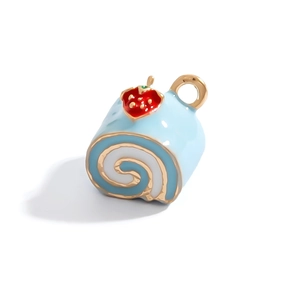Close-up of a blue cake roll pendant with a red strawberry detail and golden hook