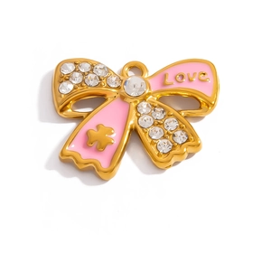 Detailed macro view of bowknot charm with 18K gold plating and pink enamel Love engraving