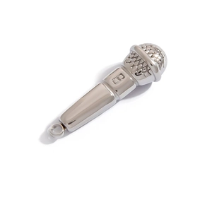 Close-up of silver microphone pendant with polished finish and letter B engraving