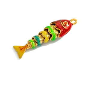 Macro shot of flexible multi-jointed gold fish pendant with colorful enamel gradient