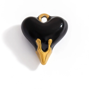 Detail view of heart pendant featuring black resin finish and 18K gold-plated accents
