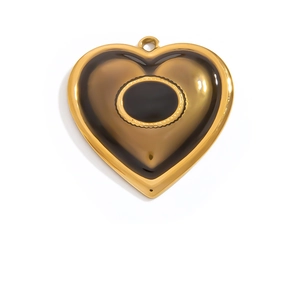 Detail of a large gold heart pendant with brown translucent inlay and a hanging loop