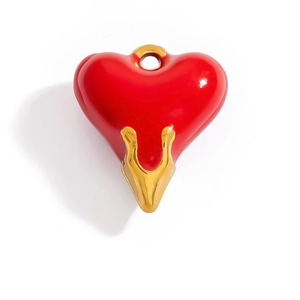 Detail of red heart pendant with 18K gold-plated setting and glossy enamel finish