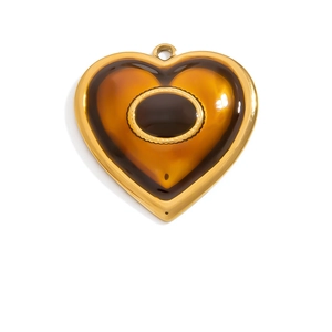 Detail of vintage heart pendant with amber resin and 18K gold plated rope border