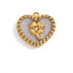 Macro detail of heart charm with gold scalloped edge, clover motif, and marble inlay