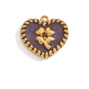 Close-up of heart-shaped purple enamel pendant with gold wavy edges and clover detail