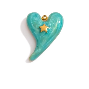 Detail view of heart-shaped charm with green marble resin and gold star inlay