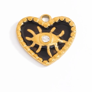Macro shot of gold plated heart pendant featuring black enamel and evil eye detail