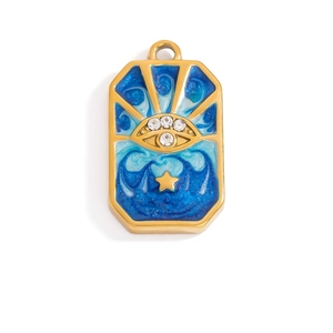 Macro detail of 18K gold plated evil eye pendant with blue enamel and crystal inlay