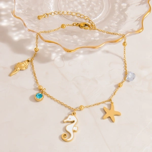 Golden stainless steel anklet with seahorse star and seashell ocean themed charms