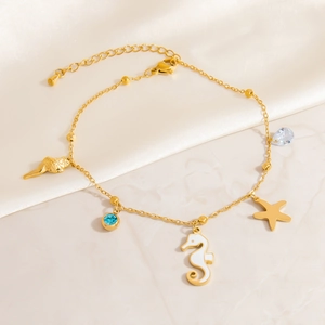 Detail of 18K gold stainless steel anklet with seahorse and starfish charms